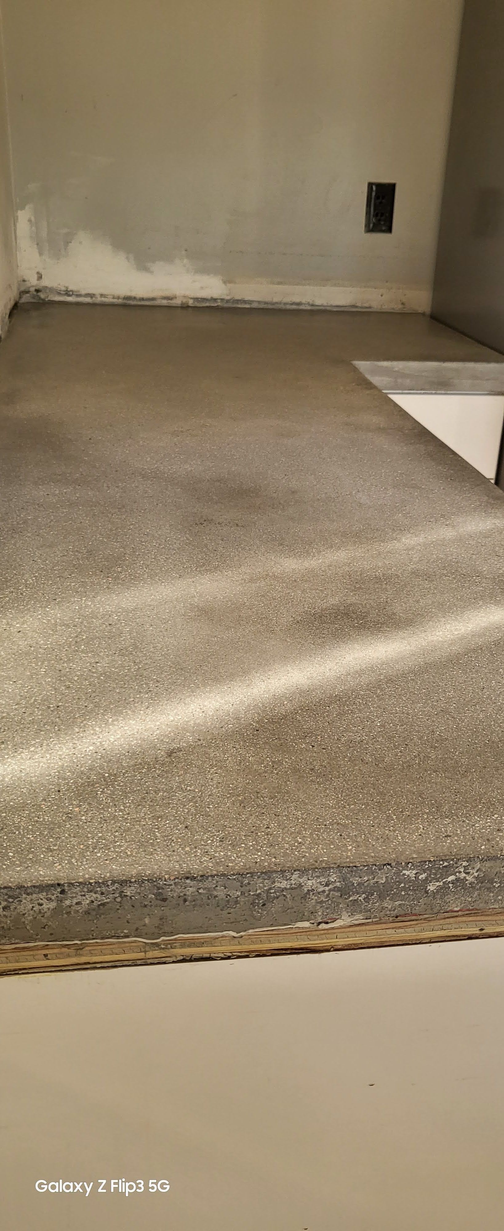 A close up of a concrete floor in a room.