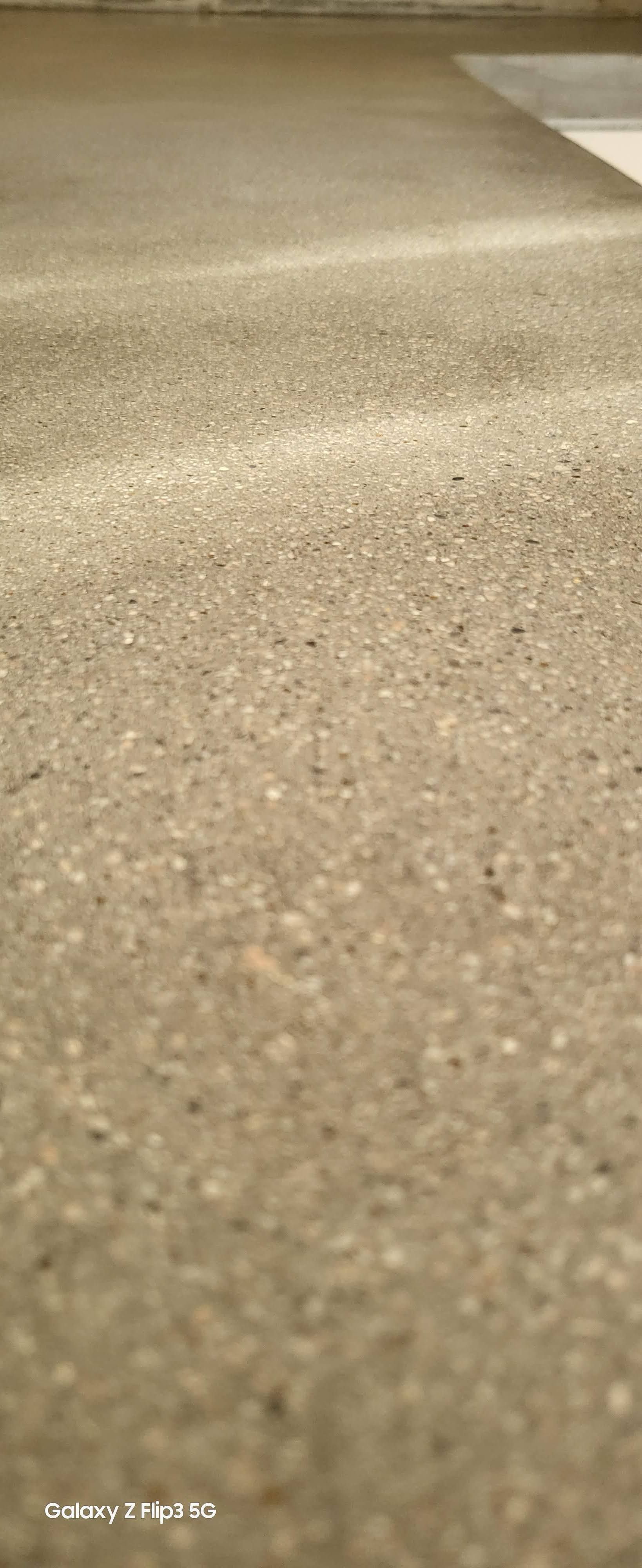 A close up of a carpeted floor with a lot of small stones on it.