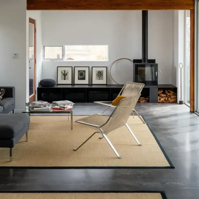 a polished concrete floor in a living room filled with furniture and a fireplace in La Quinta CA