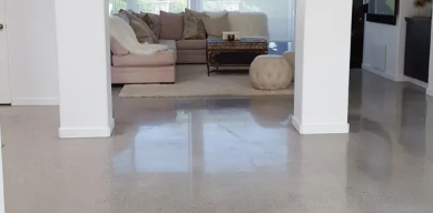 A living room with a couch , coffee table , and rug.