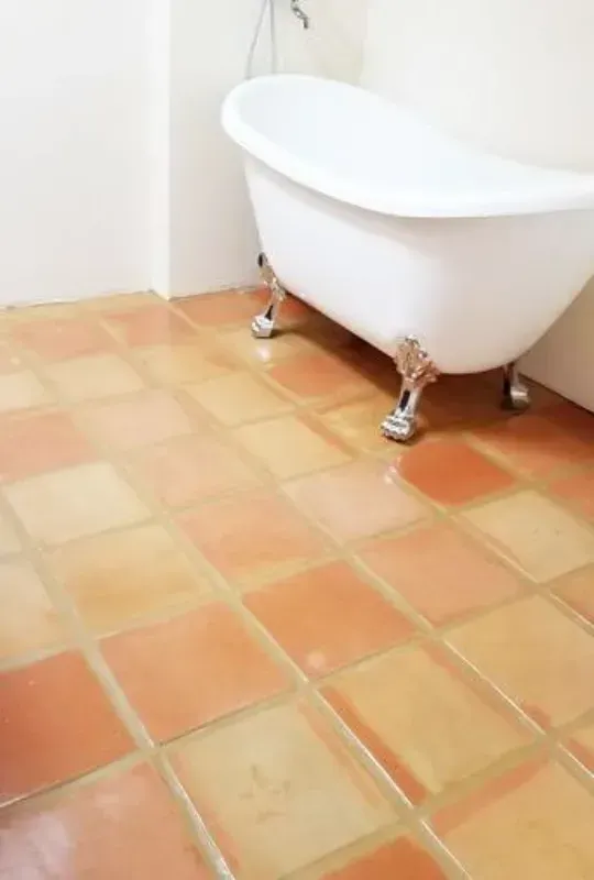 a bathtub is sitting on a cleaned grout and tiled floor in a bathroom in Yucca Valley, South California.