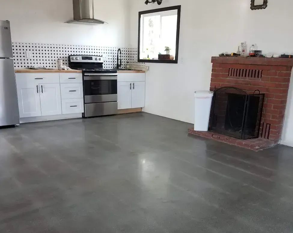 A large empty garage with a concrete floor and a white garage door.