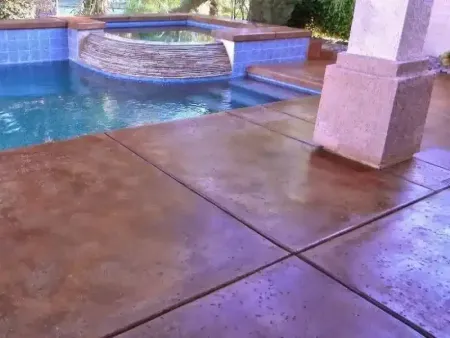 a concrete stained patio with a swimming pool in the background in Yucca Valley, South California