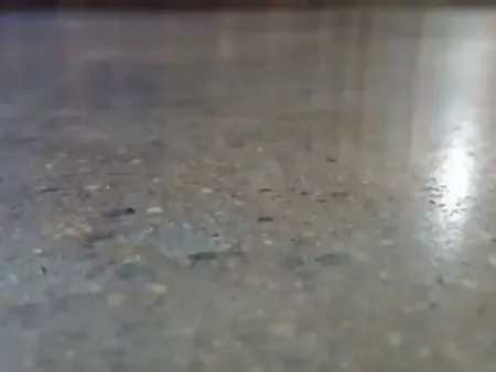 a close up of a restored concrete floor with a lot of small stones on it in Yucca Valley, South California.