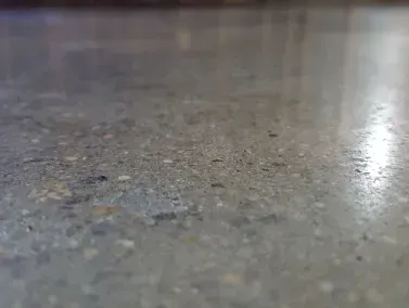 a close up of a restored concrete floor with a lot of small stones on it in Yucca Valley, South California.