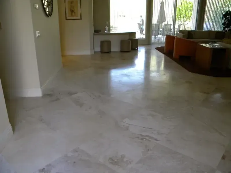 A living room with a white marble floor and orange furniture