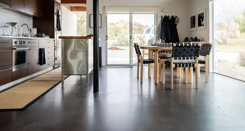 A kitchen and dining room in a house with a table and chairs.