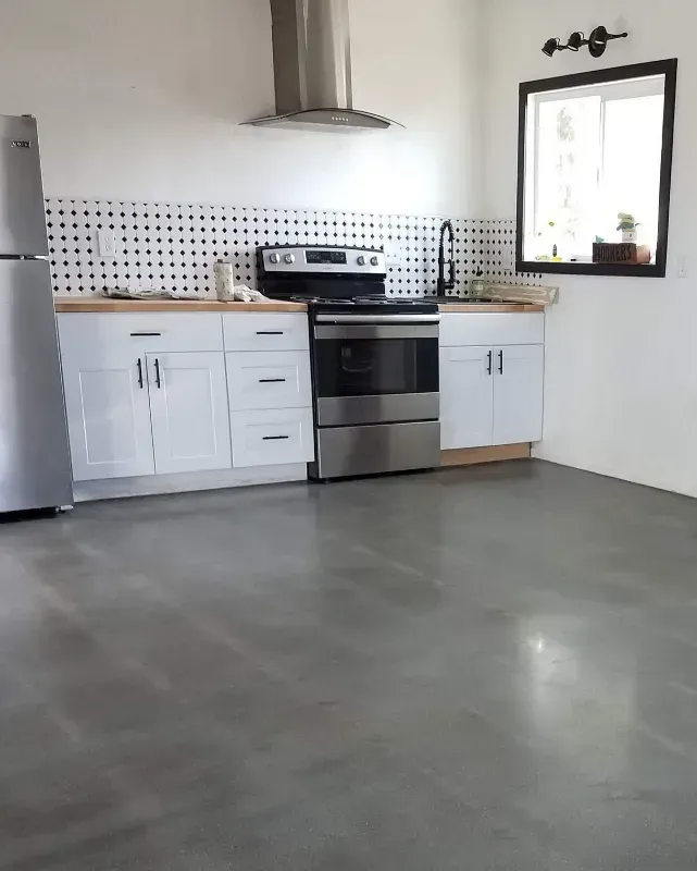 A kitchen with stainless steel appliances and white cabinets