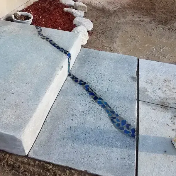 A concrete patio with a hose connected to it and a window.