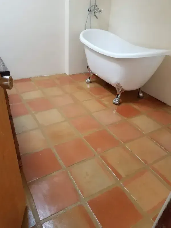 A bathtub is sitting on a tiled floor in a bathroom.
