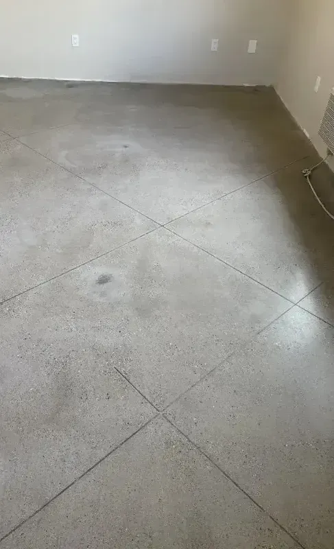 A room with a concrete floor and white walls.