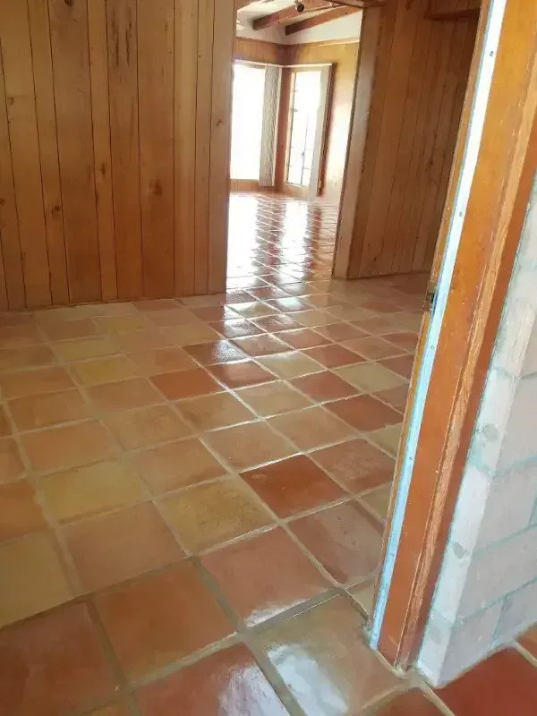 A room with a tiled floor and wooden walls.