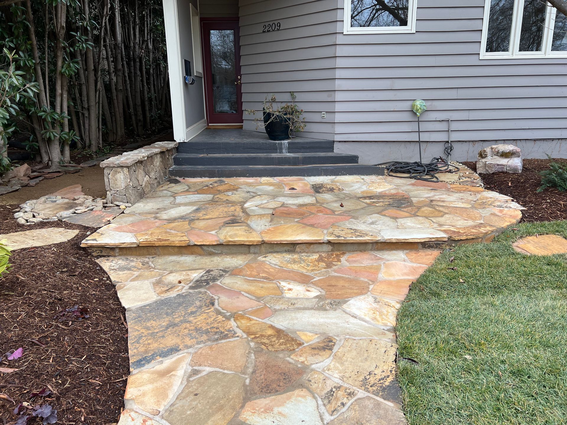 A stone walkway leading to the front door of a house.