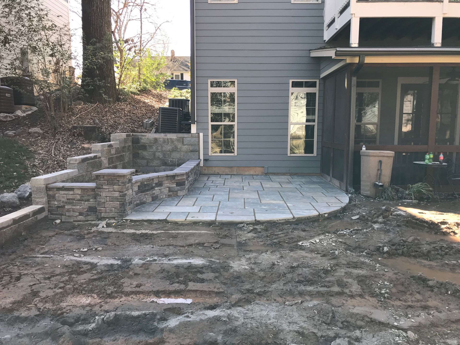 A patio is being built in front of a house.