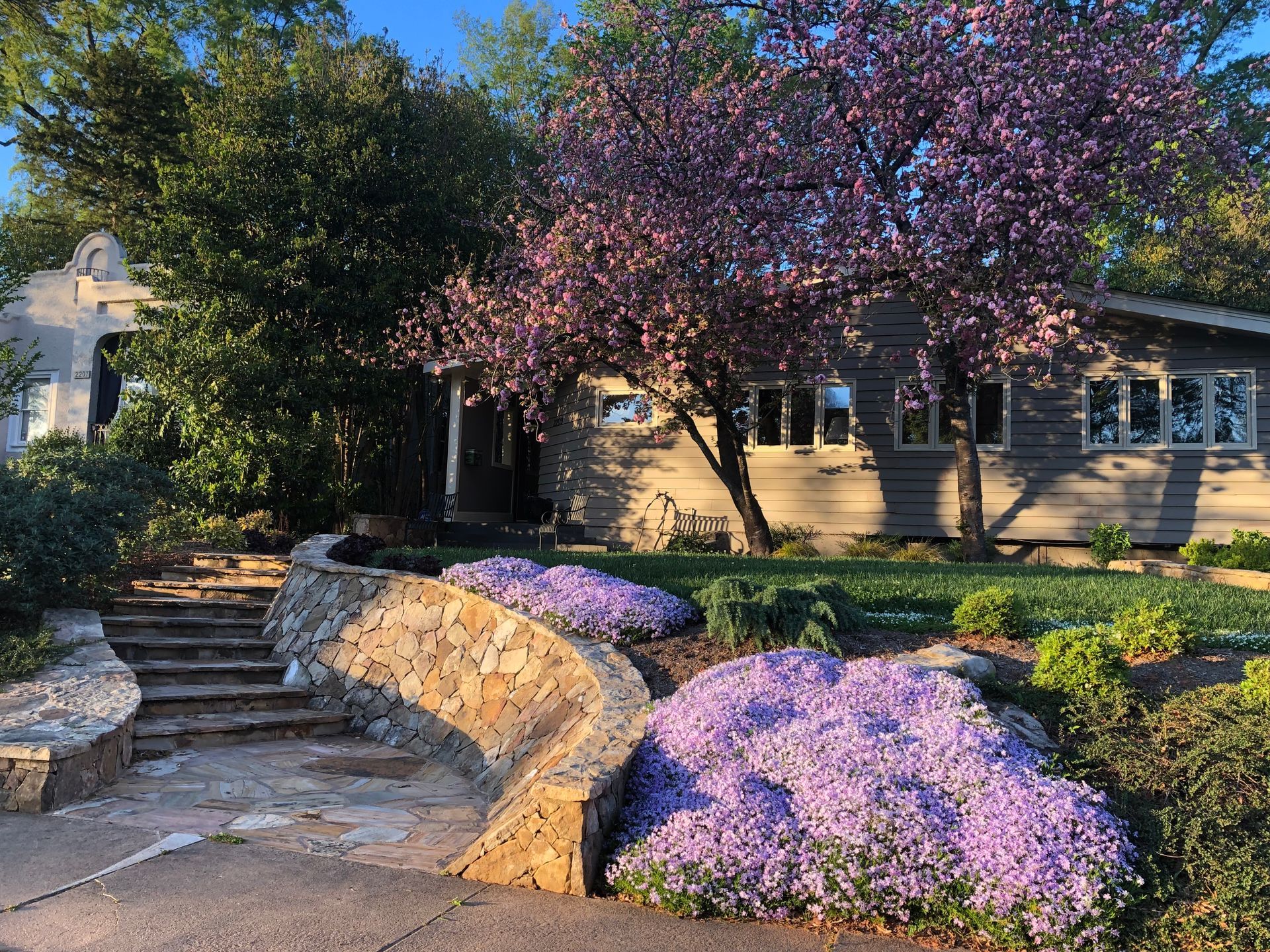 A house with purple flowers in front of it