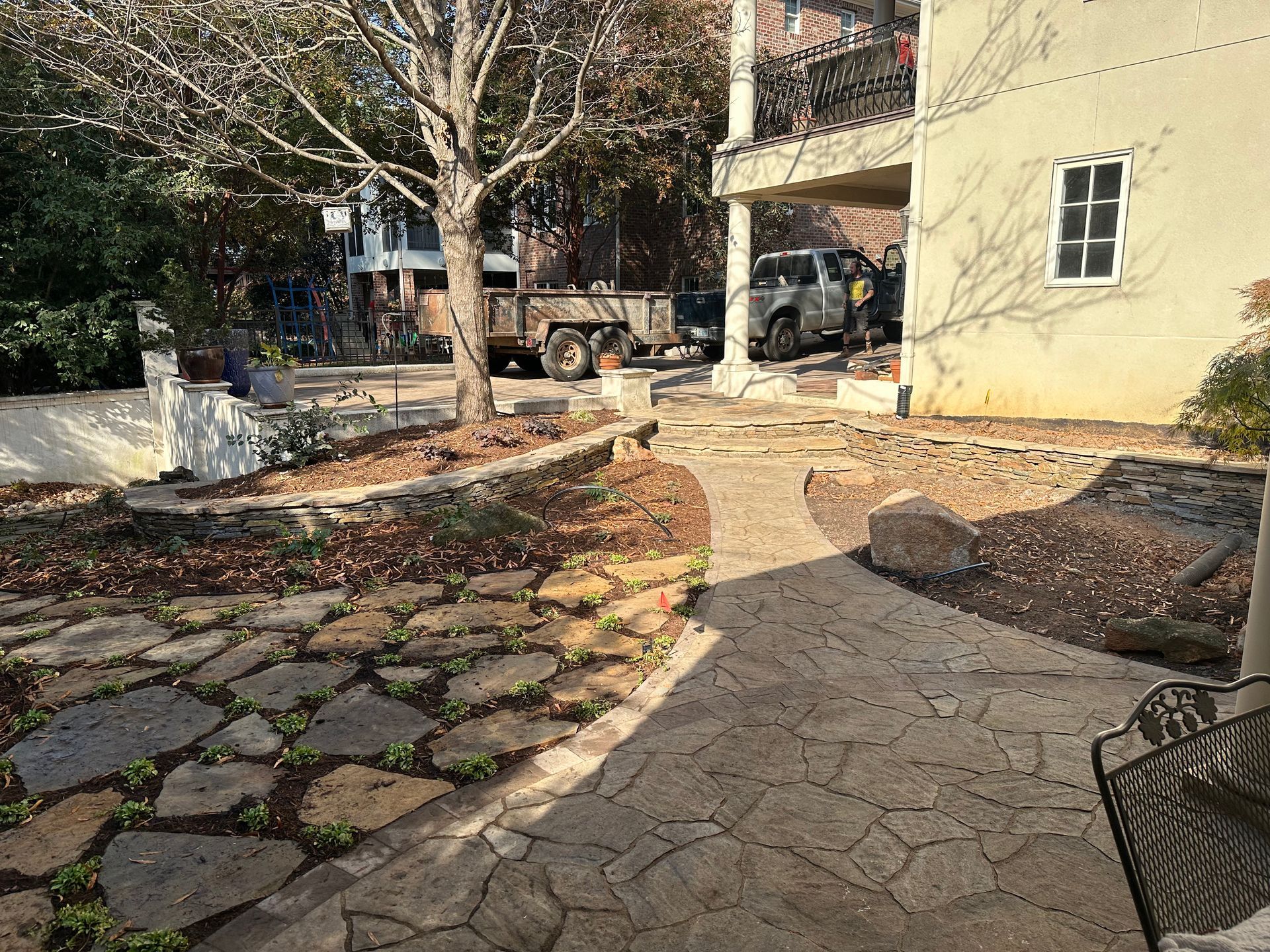 A truck is parked in the backyard of a house.