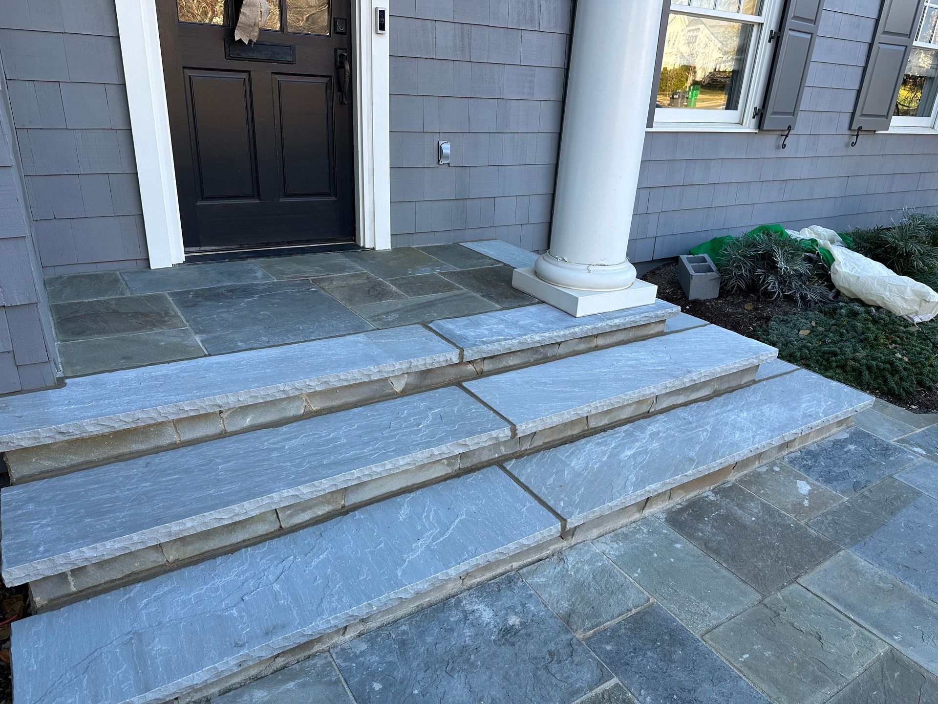 A set of stairs leading up to the front door of a house.