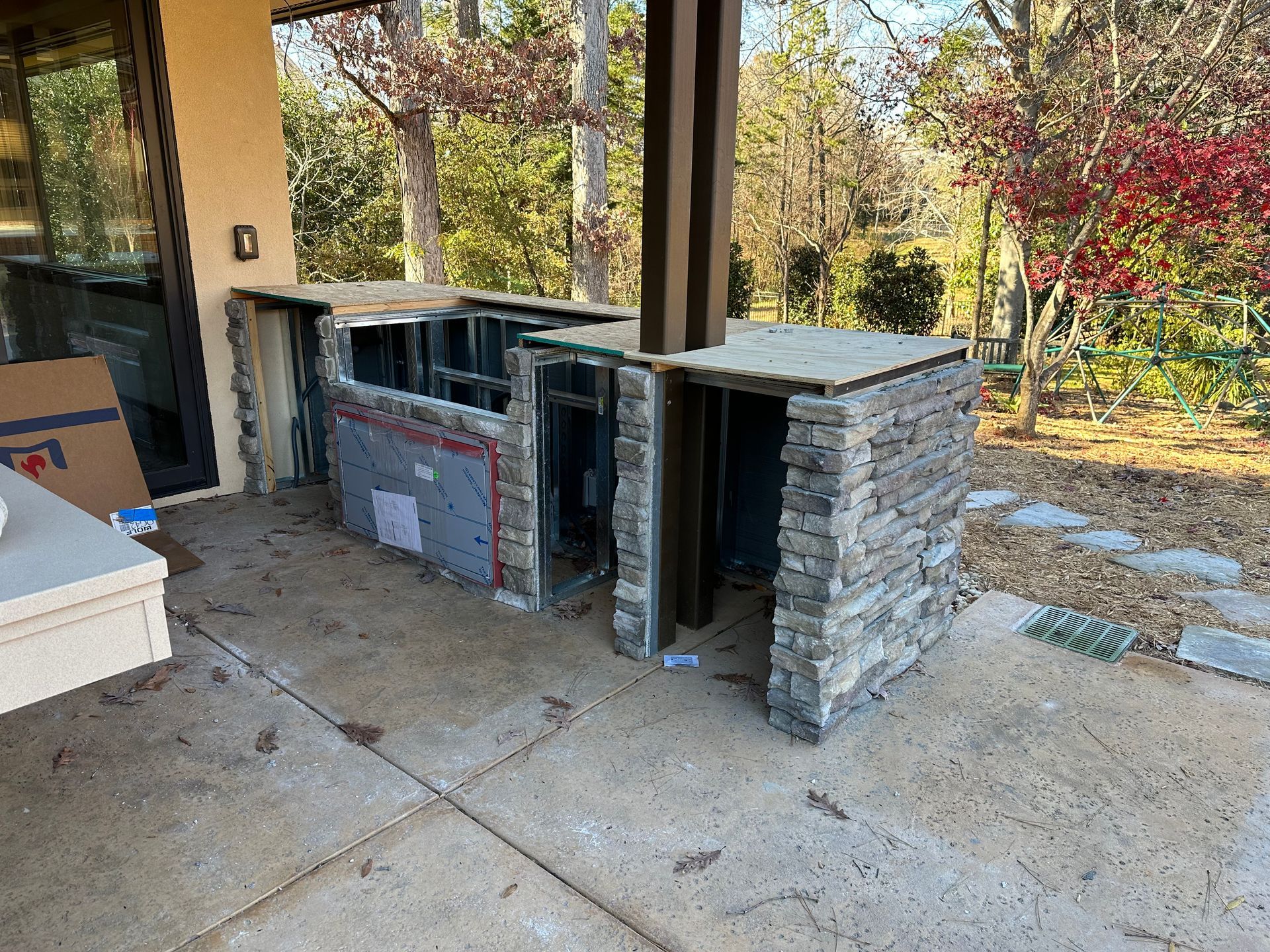 A kitchen is being built on the side of a house.