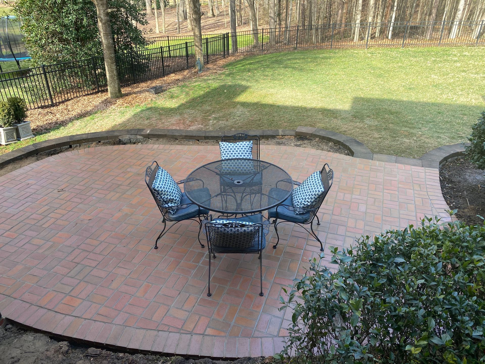 A patio with a table and chairs in the middle of it.