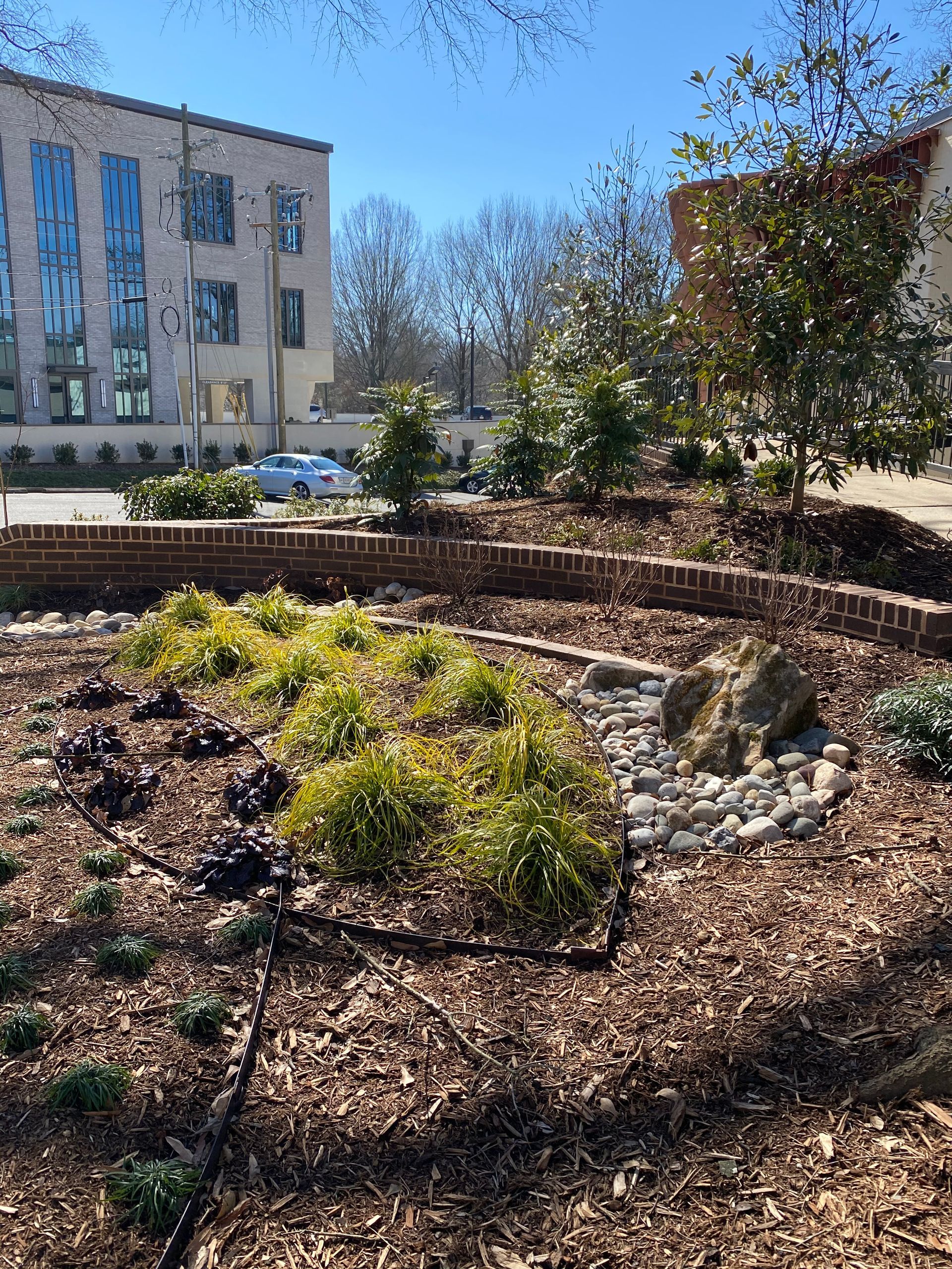 There is a large building in the background and a garden in the foreground.