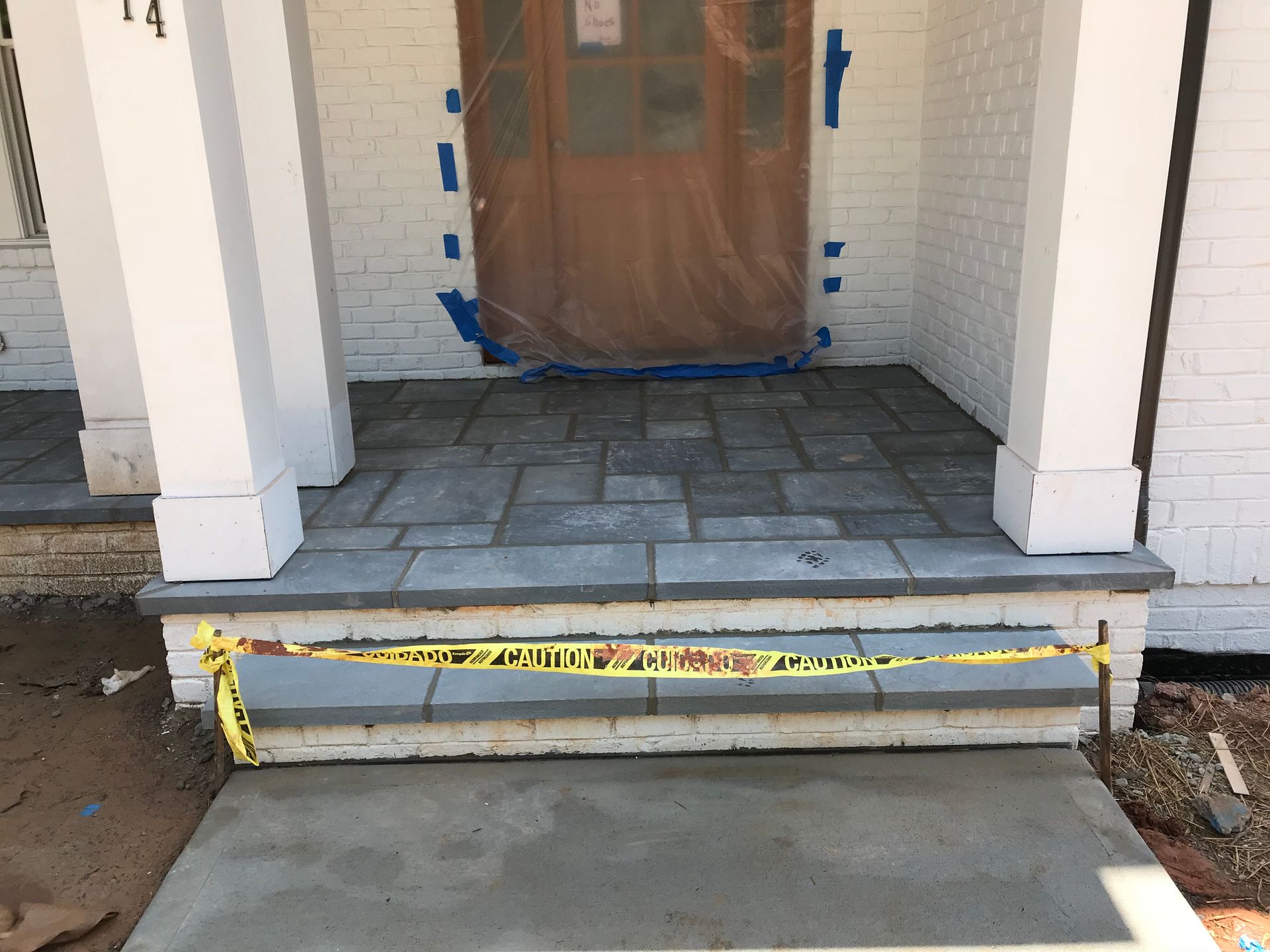 The front porch of a house is being remodeled