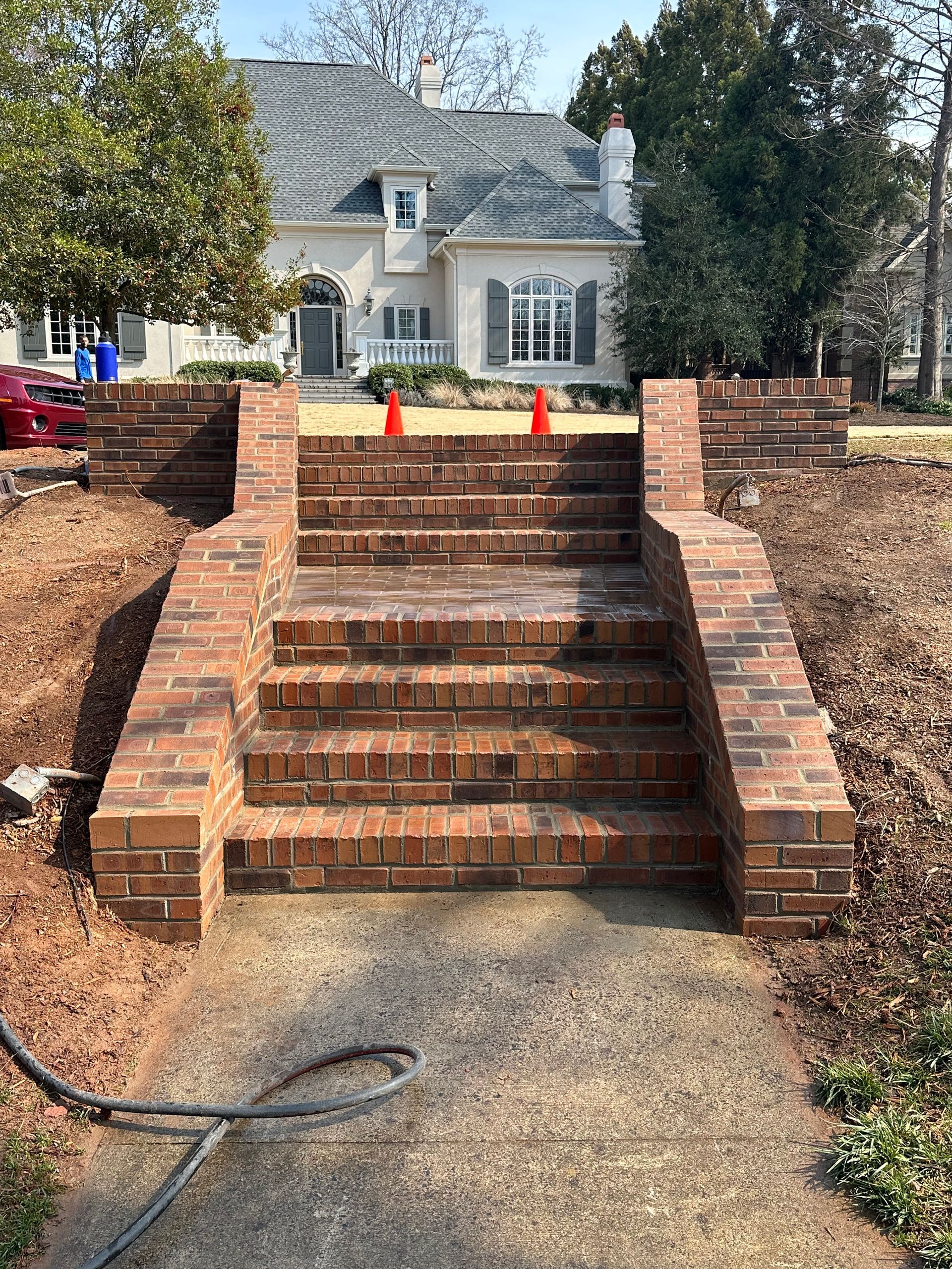 A set of brick stairs leading up to a house.