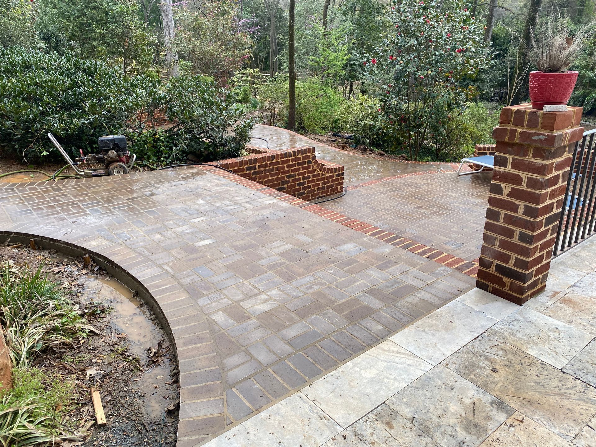 A brick walkway is being built in a backyard.
