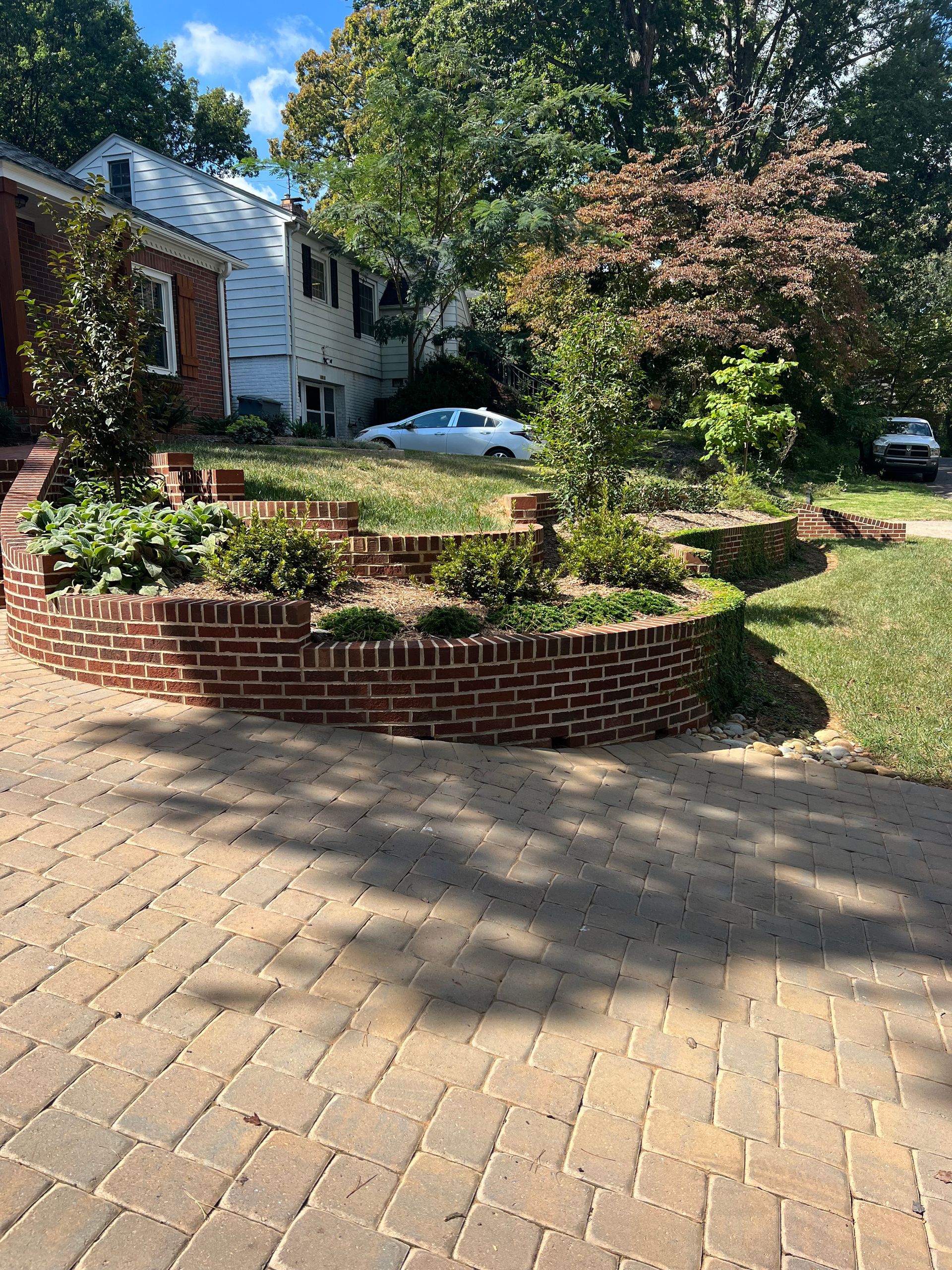 There is a brick wall in the middle of the driveway.