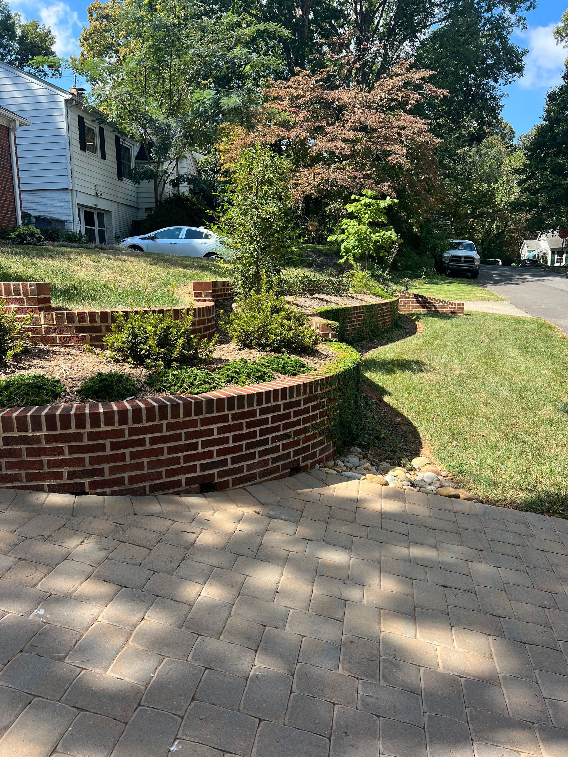 There is a brick wall in the middle of the yard.