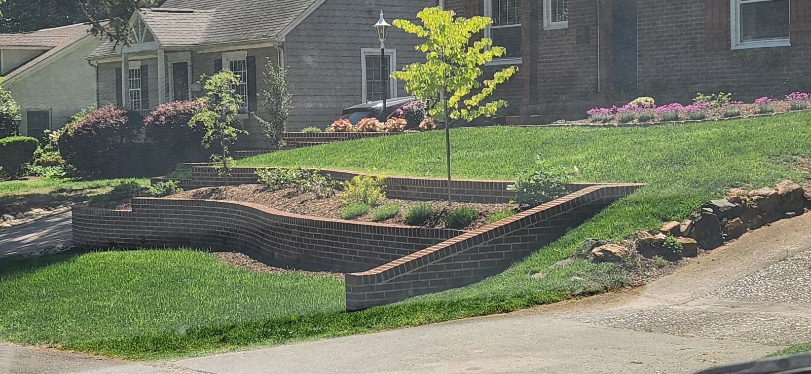 A house with a brick wall in front of it