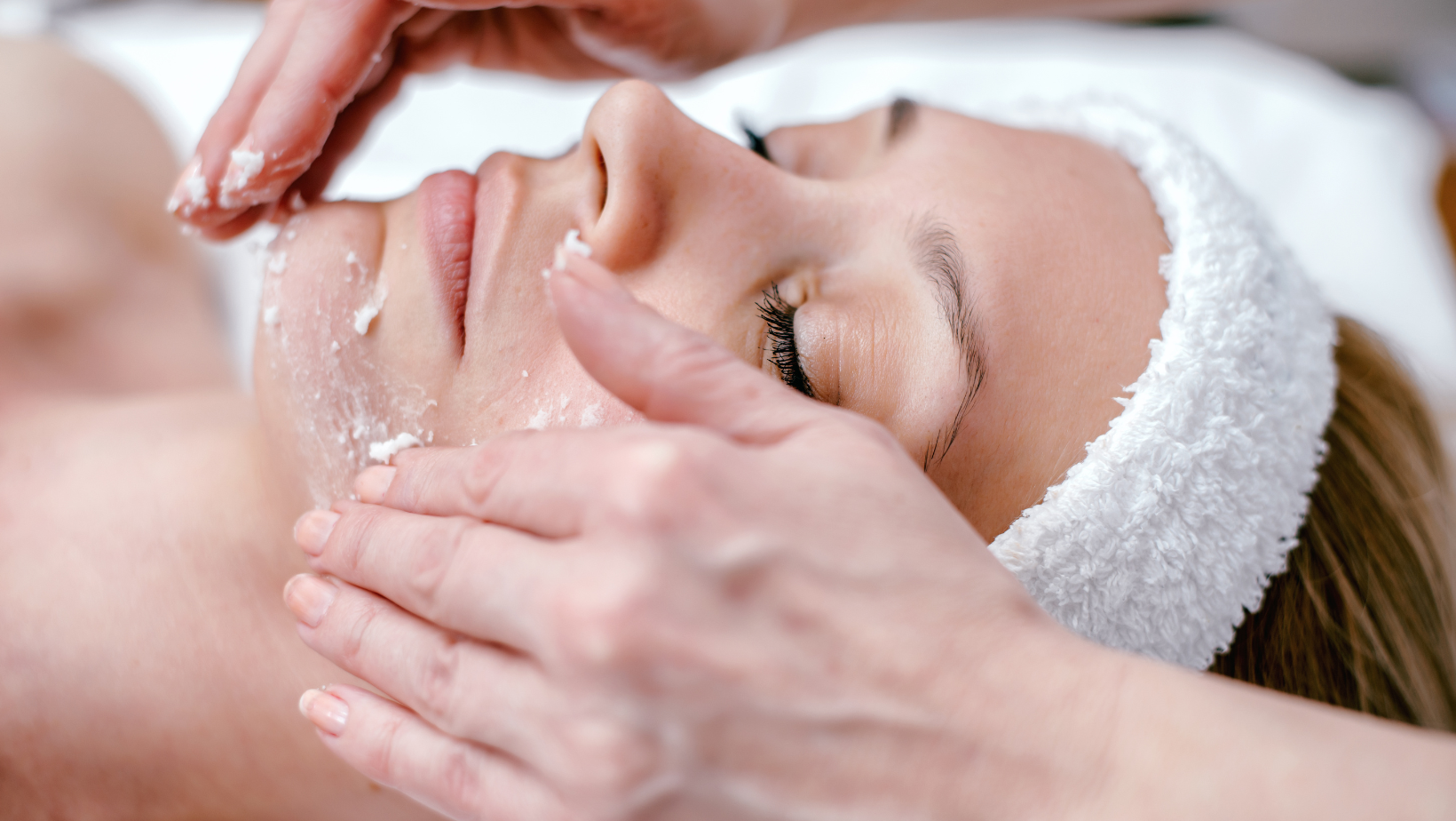 A woman is getting a facial treatment at a spa.