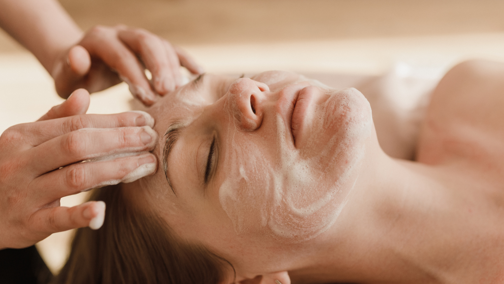 A woman is getting a facial treatment at a spa.