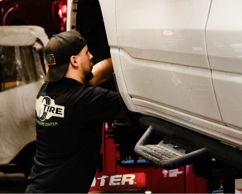 Mechanic working on a car tire | Pro Tire & Automotive Center