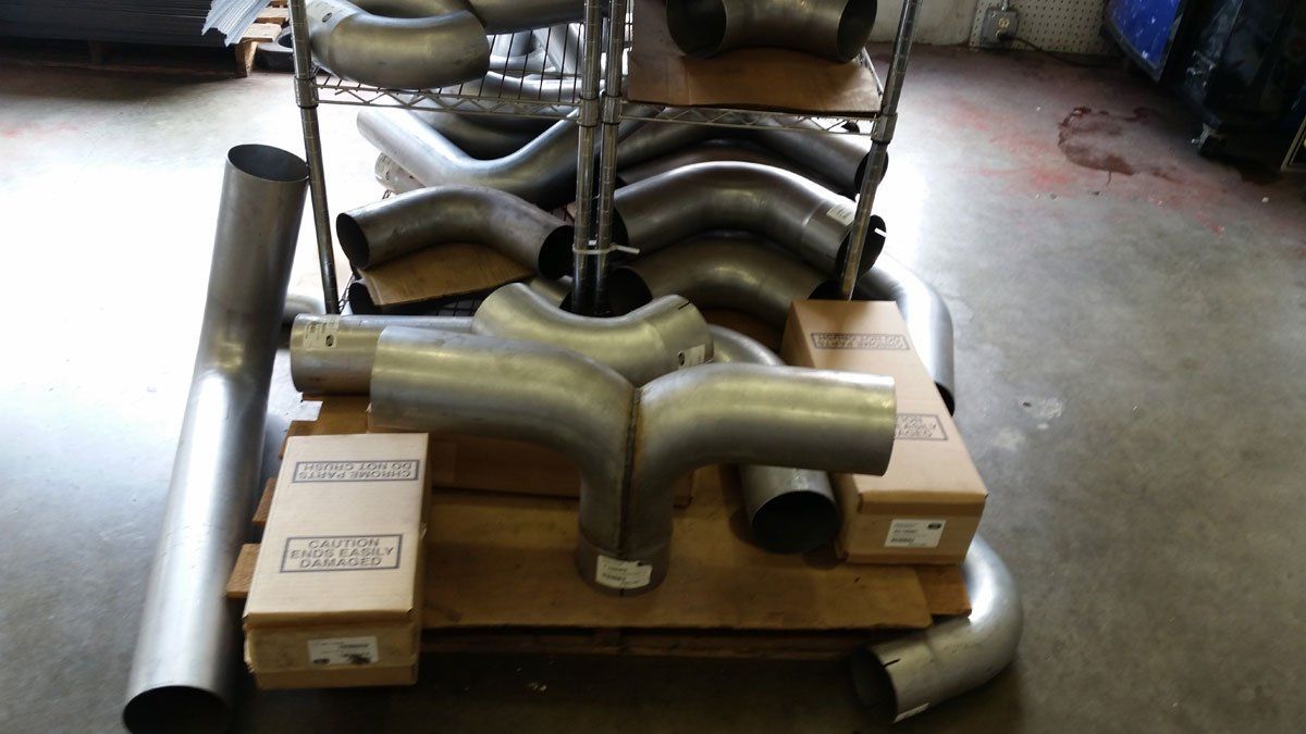 A collection of steel exhaust pipes
