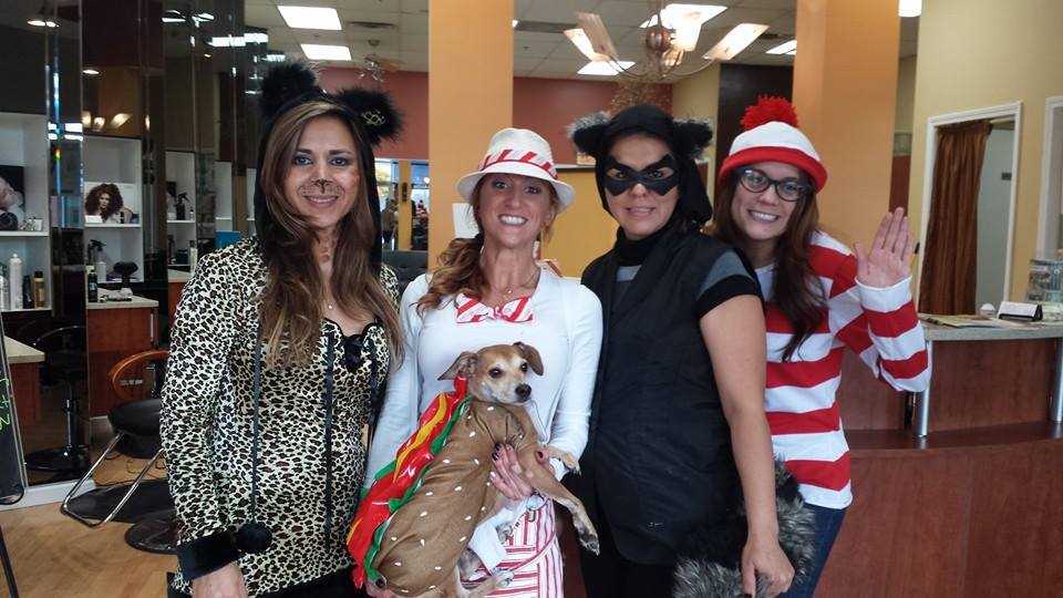 A group of women posing for a picture with a dog