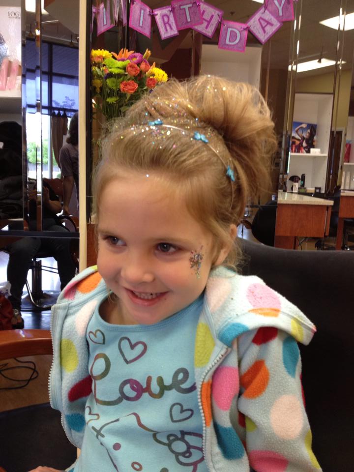 A little girl wearing a shirt that says love on it