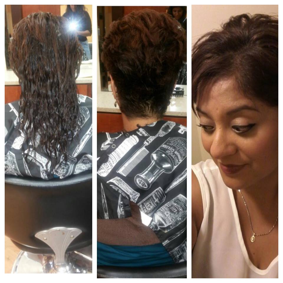 A woman is getting her hair cut in a salon