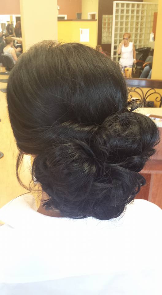 A woman is getting her hair done in a salon.