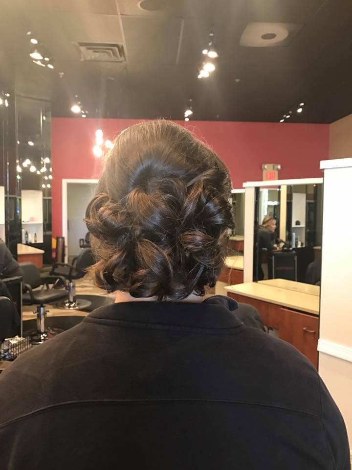 A woman is getting her hair done in a salon.
