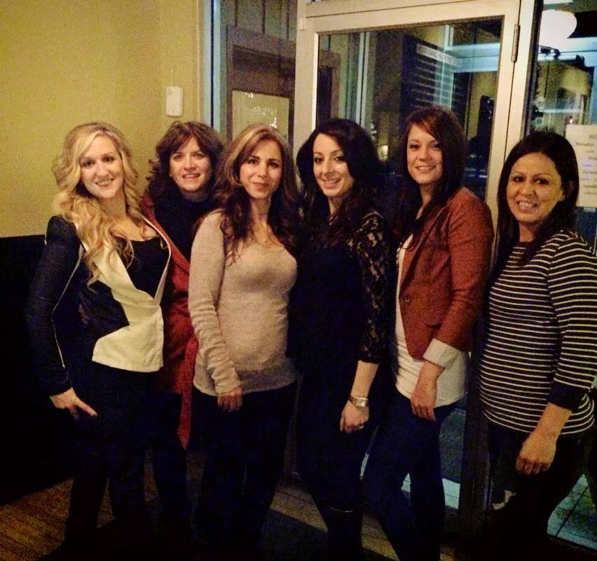 A group of women are posing for a picture together