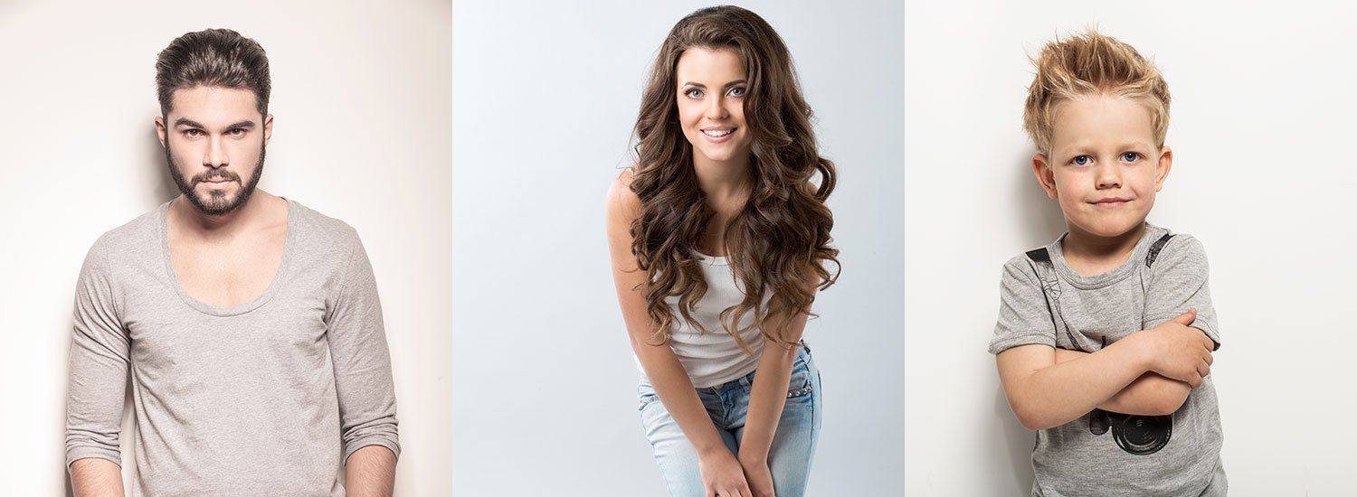 A man , a woman , and a boy are standing next to each other.