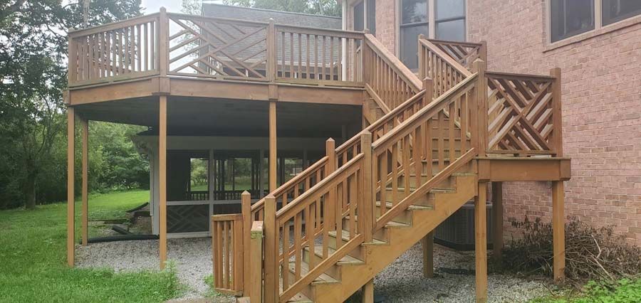 A wooden deck with stairs leading up to it