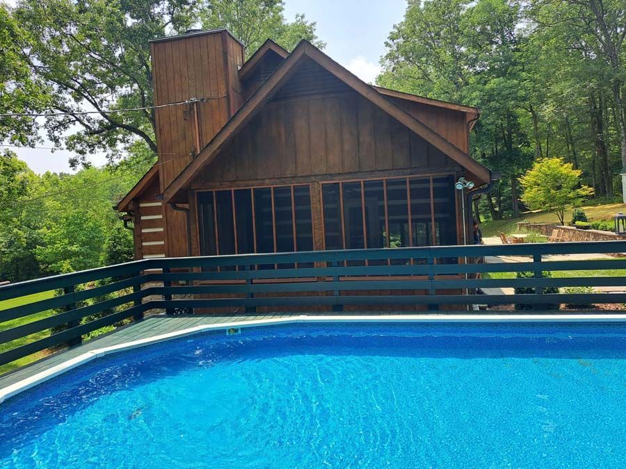 A large house with a swimming pool in front of it