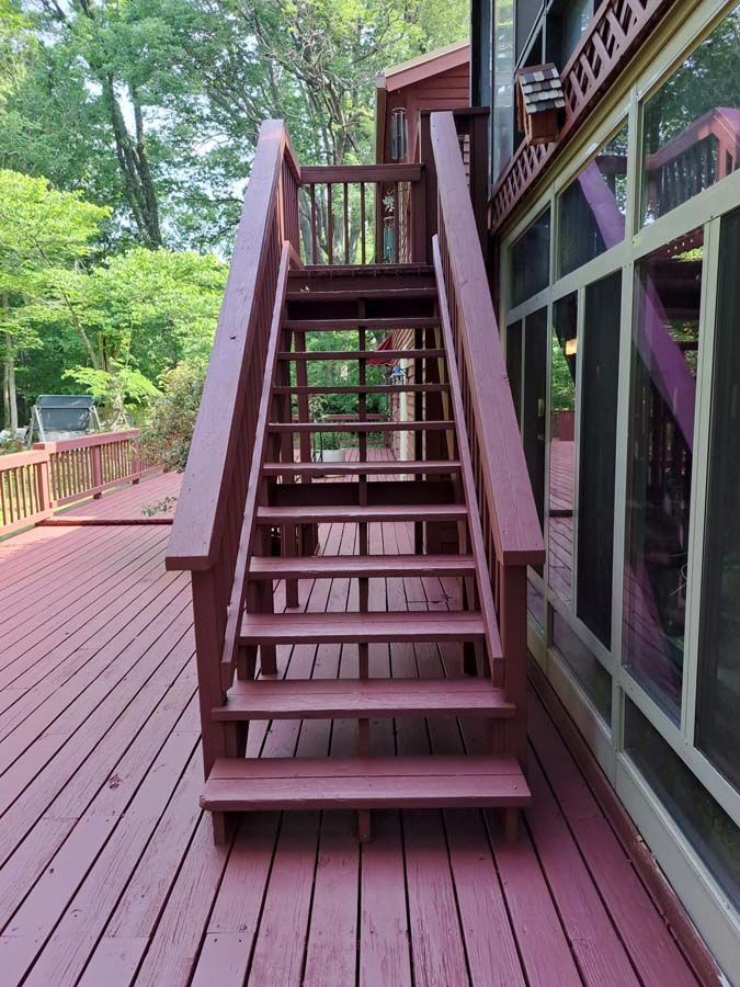 A wooden deck with stairs leading up to it