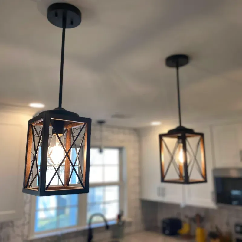 Two pendant lights are hanging from the ceiling in a kitchen