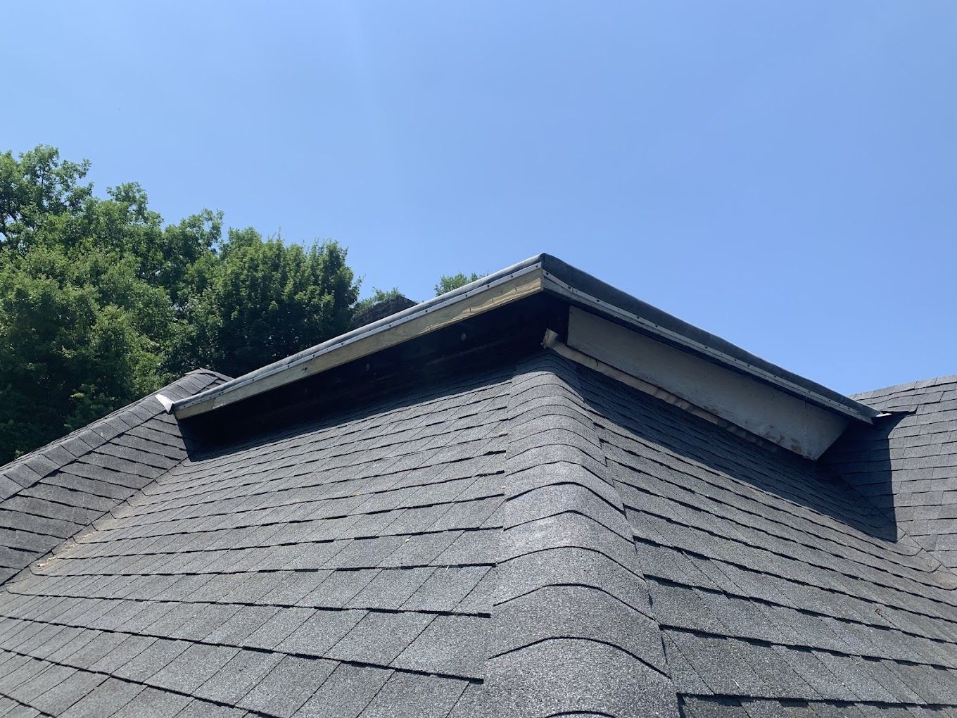 A close up of a roof with a blue sky in the background.