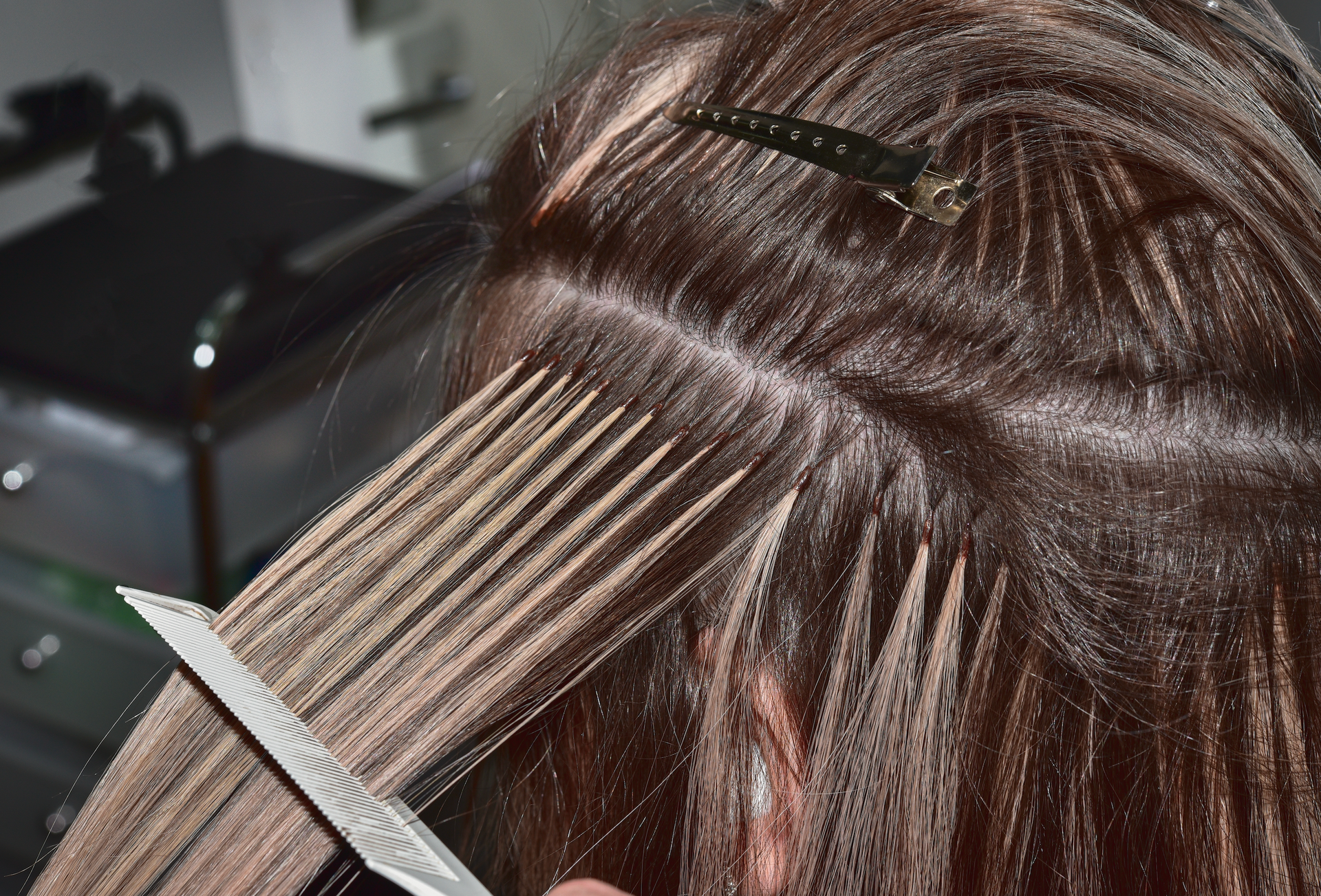A woman is getting her hair cut by a hairdresser.