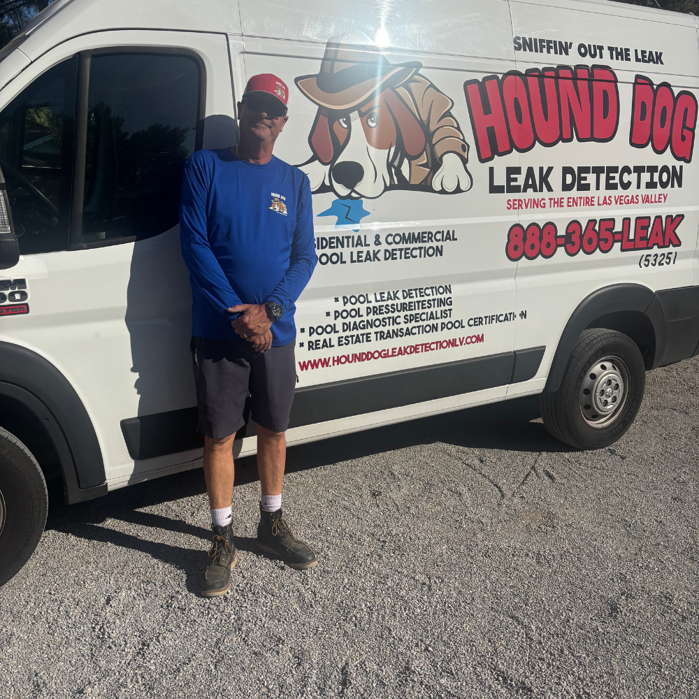 Man standing beside a white Hound Dog Leak Detection van with red and black lettering.