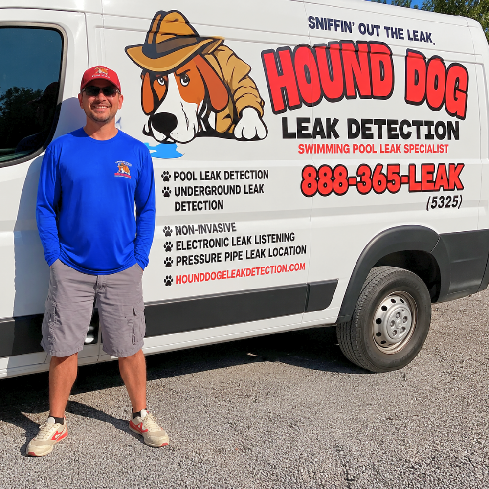 Man standing beside a white Hound Dog Leak Detection van with bold red and black signage.