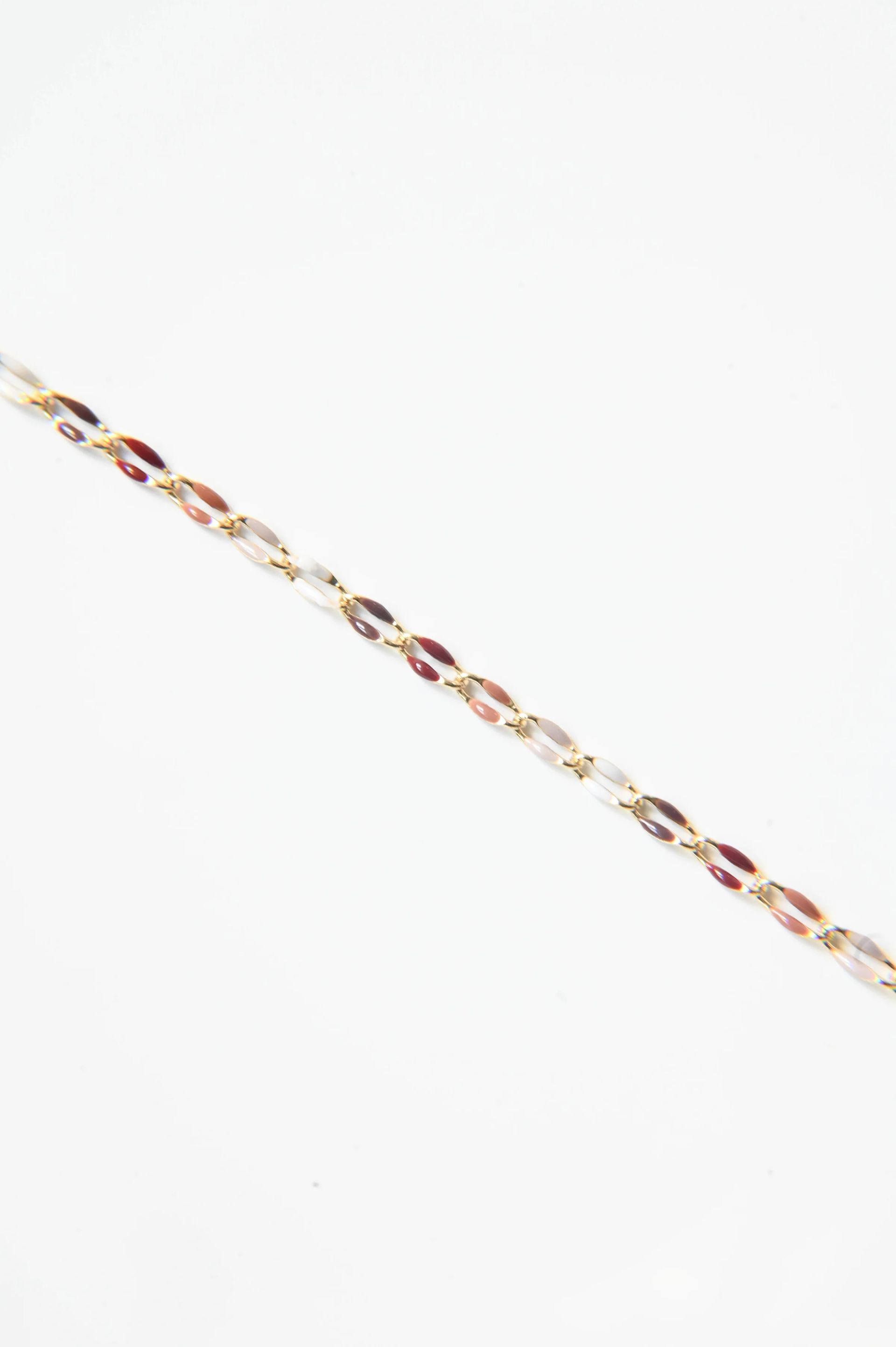 A close up of a bracelet on a white background.